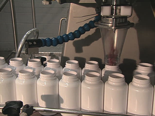 Pill bottles being filled. 