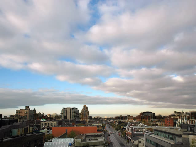 Time lapse. Sunset directly ahead in the city.