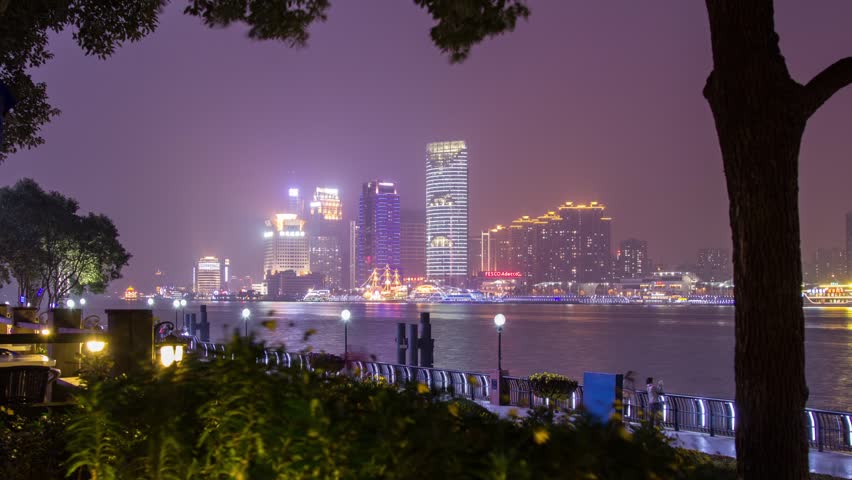 Time Lapse of Busy Boat Traffic at Night by the river in Shanghai, China