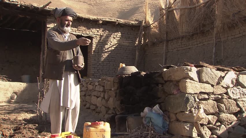 YAFTAL, AFGHANISTAN - NOVEMBER 12: Farmer in Yaftal, remote area of northeast Afghanistan, is feeding his chickens on November 12, 2011.