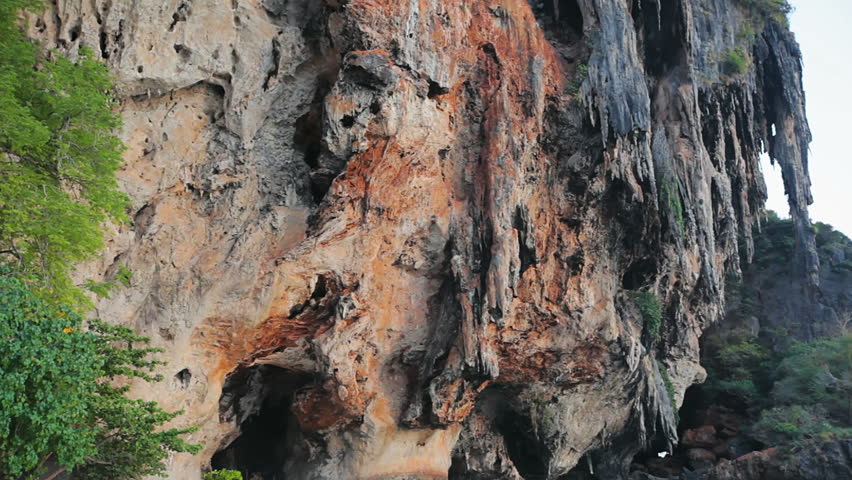 1920x1080 video - High limestone rock with stalactites from down to top 