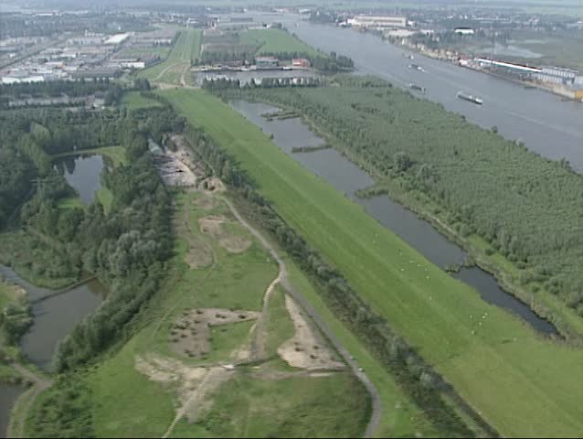 Industrial area along River Lek (Rhine) at Alblasserwaard, South Holland, The Netherlands. South Holland is one of the most densely populated and industrialized areas in the world.