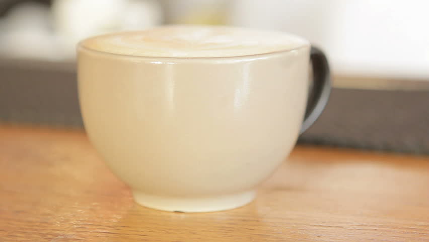focus change on a white cup of coffee placed on the counter
