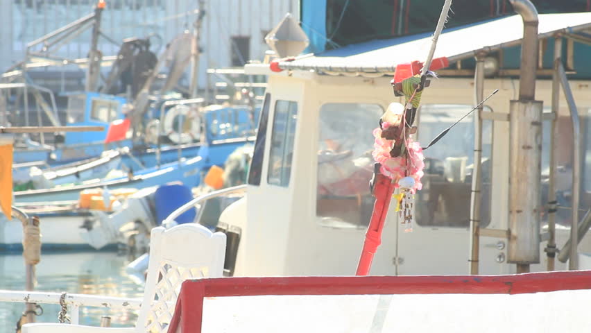 uniquq personal little boats anchored at Jaffa port and two women pass by in the back