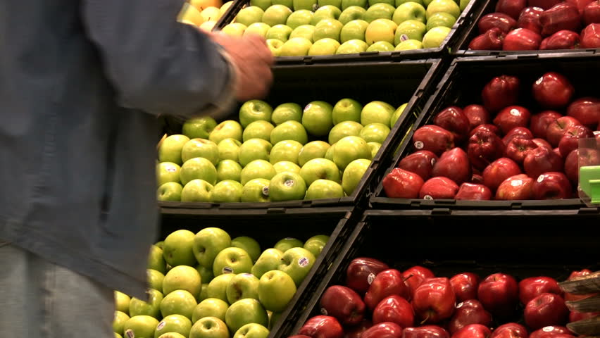 Selecting apples at a grocery.