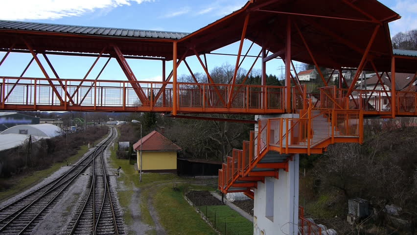 AERIAL: Free runners doing flips in railroad overpass