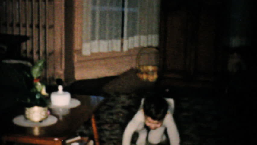 JOHNSTOWN, NEW YORK, 1957: A cute little boy looking hard to find yummy Easter egg treats in 1957.