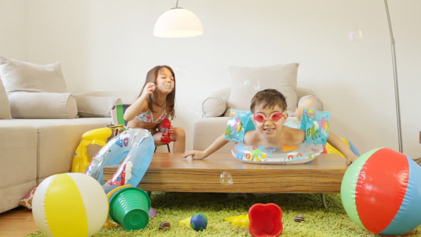 Kids playing in the living room, fantasize about they are on a beach. 