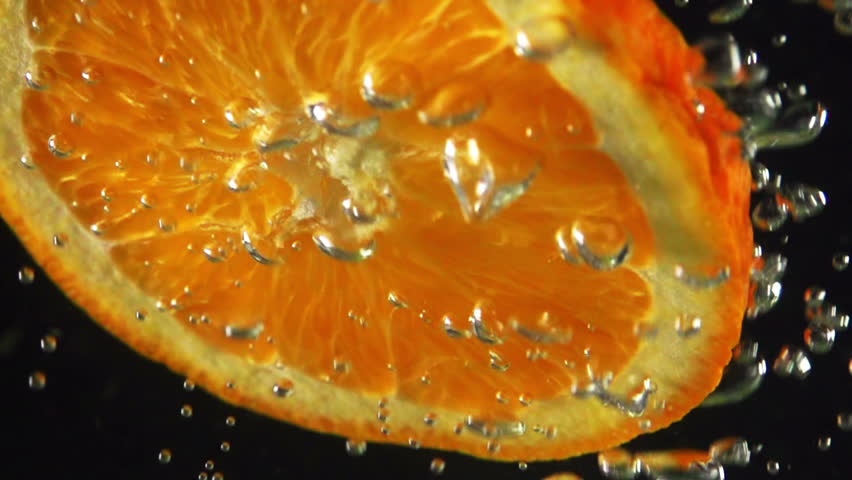 Air bubbles falling on the slice of orange fruit HD 480fps