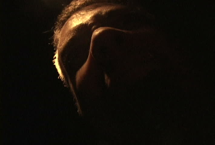 Horror movie scene man growling at cameras.