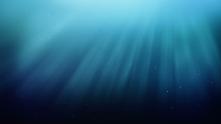 Ocean waves, underwater with light rays.