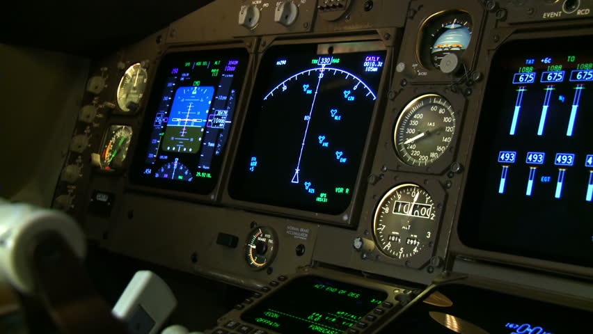 Detail of instruments being adjusted in a Boeing 747 cockpit. Shot with a hand-held camera.