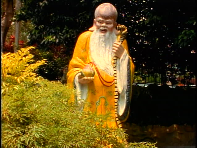 Singapore Tiger Balm Gardens, wise old man in yellow gown, tilt up