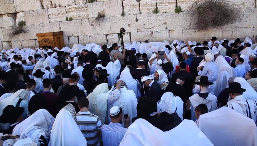JERUSALEM, ISRAEL -  MARCH 28: Cohanim raise their hands during Priestly Blessing  (Hebrew - Birkat Cohanim) at the Western Wall plaza during the Passover Holiday, March 28 2013 in Jerusalem, Israel.