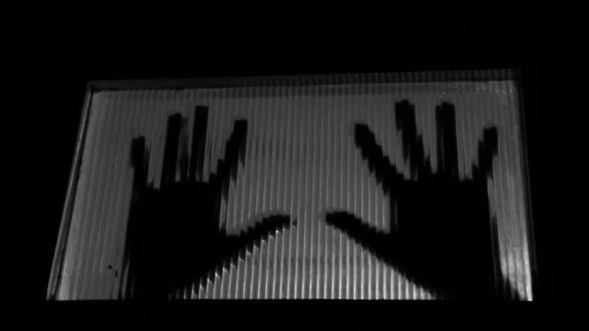 Trapped man knocking on door, hands shadow abstract. Black and white.