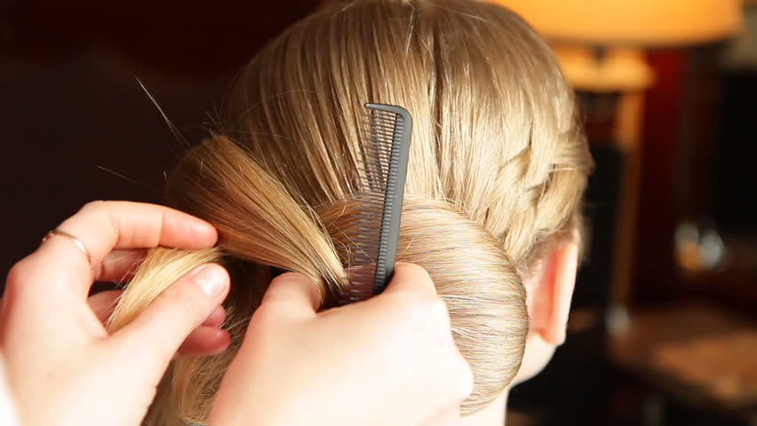 Hairdresser making hairstyle for bride. Close-up.
