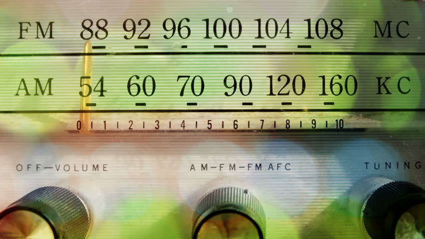 a cool vintage radio with the dial moving across the different frequencies
