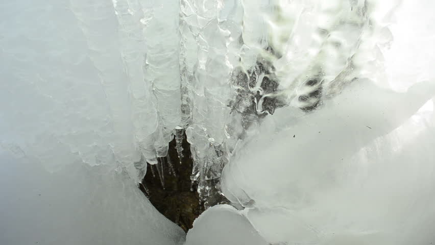 cascade ice and icicle in mountain cave and water fall drop melt in winter.