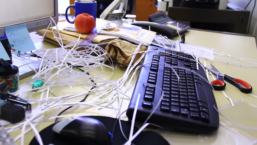 Chaotic office with all sorts of supplies and food. A bad worker, lazy person.