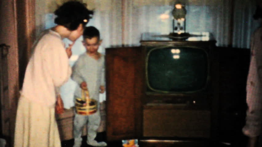 JOHNSTOWN, NEW YORK, 1957: Brothers and sisters look for all their yummy Easter egg treats in the living room in 1957.