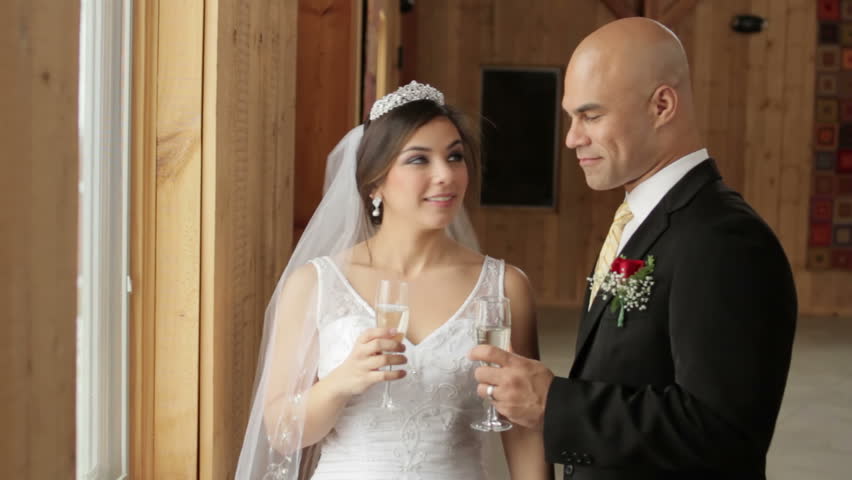 Couple celebrating wedding by toasting each other with Champagne.