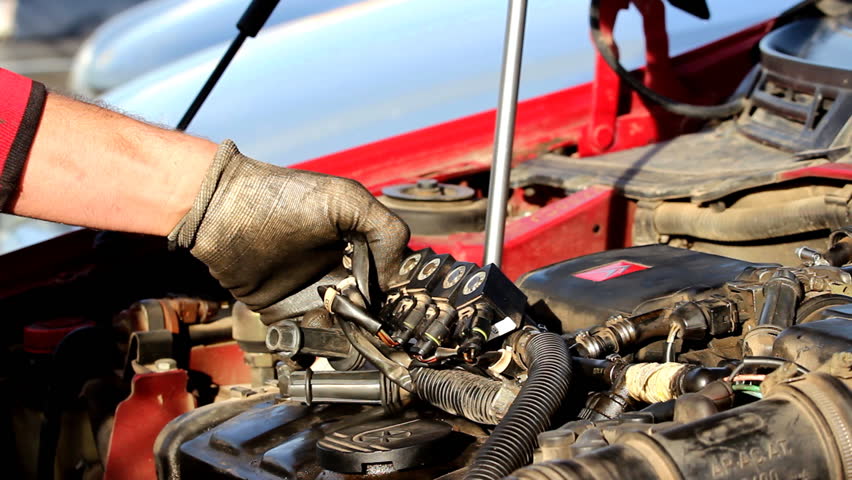 Mechanic hands - Mechanic fixing the car.