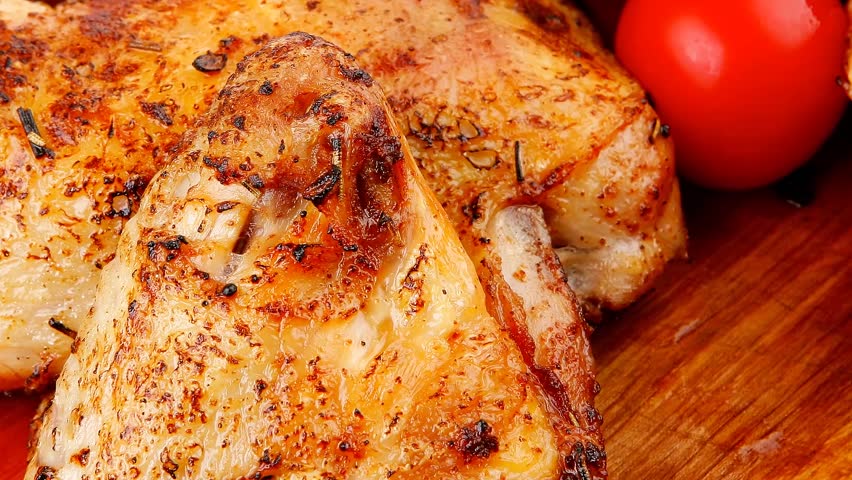 roast meat : chicken legs garnished with green sprouts and peppers on wooden plate 