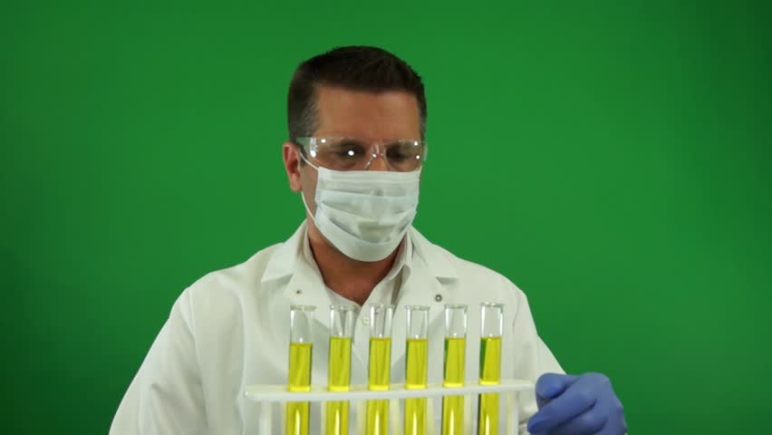 Laboratory Worker with Mask Examining Urine Samples on a Green Screen