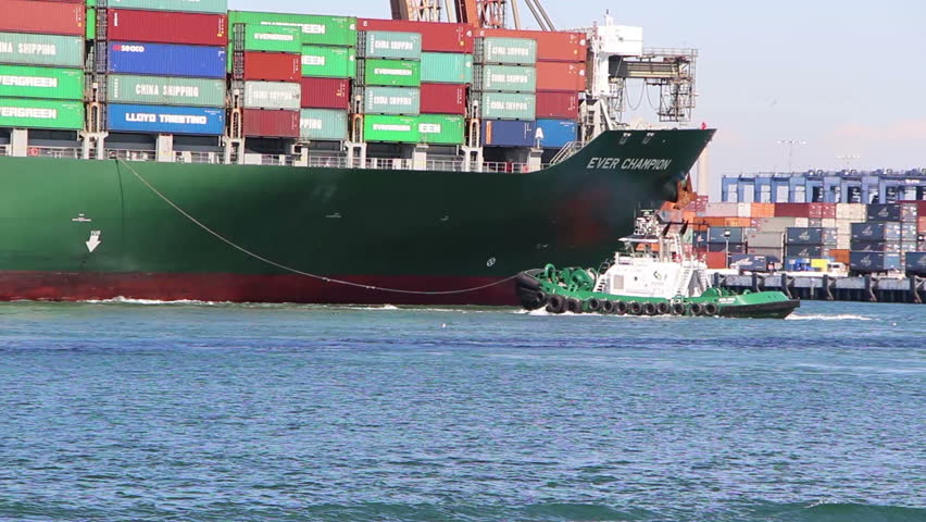 LOS ANGELES - NOV 2: Tugboat - FOSS Alta June - working the bow of the container ship Ever Champion IMO: 9293765 in Los Angeles on November 2, 2012
