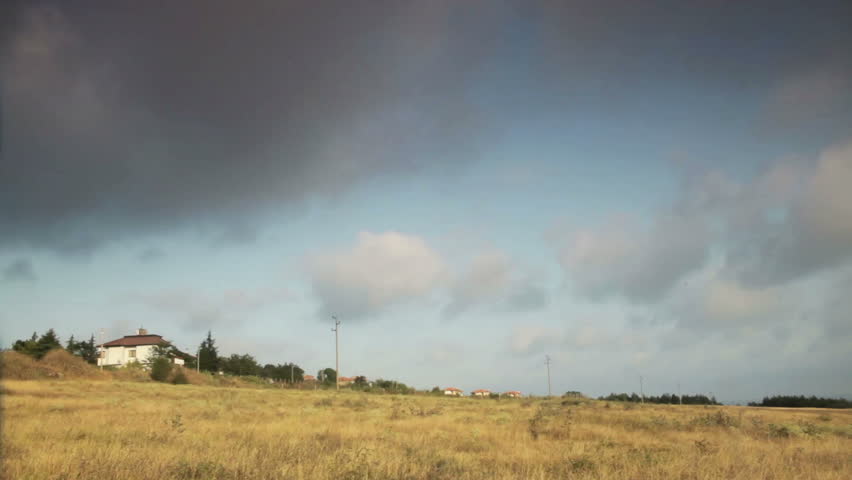 Landscape time lapse with running clouds over the cottages