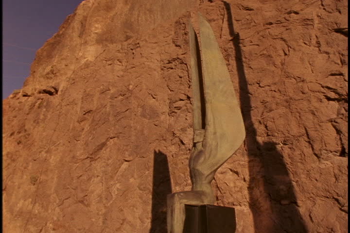 NEVADA - ARIZONA BORDER - CIRCA MARCH 1997: Camera dollies around one of the bronze Winged Figures of the Republic statues by Oskar J.W. Hansen