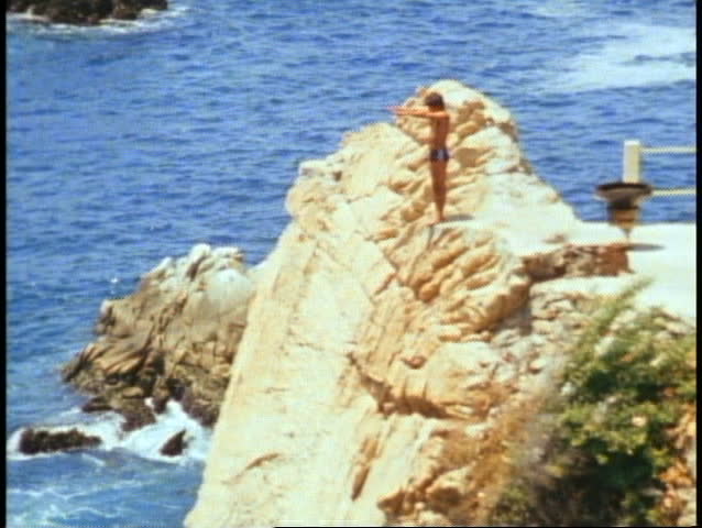 Acapulco, La Quebrada, cove, sea cliffs, close up diver, dives, zoom out wide