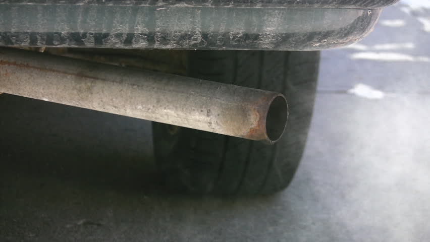 Car exhaust drips and blows vapour.