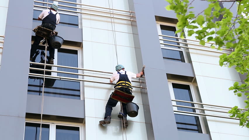 Industrial Climbers - Facade Cleaning.
Workers washing the windows facade of a modern office building. HD1080p. 