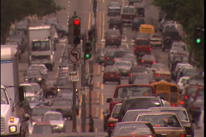 WASHINGTON, D.C. - JUNE 27, 2000: MS heavy traffic and traffic lights on Pennsylvania Avenue, a few pedestrians cross in foreground.