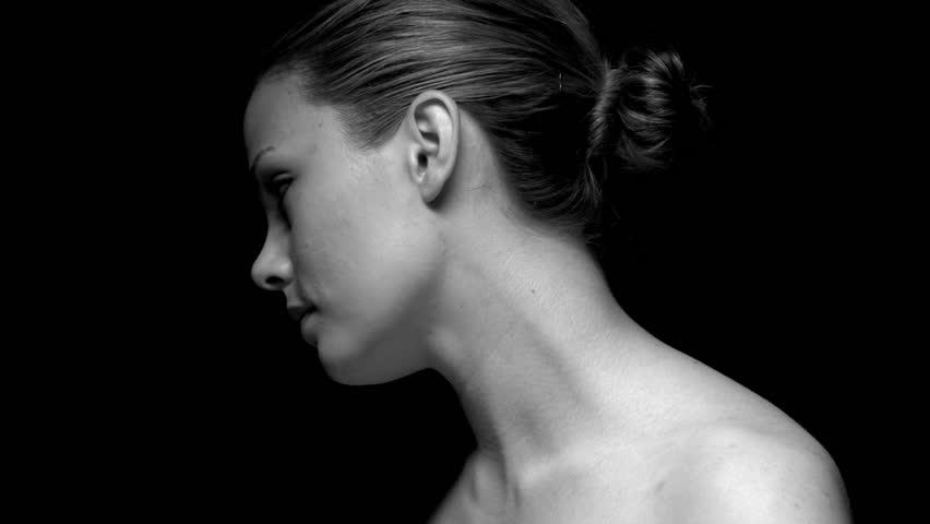 Woman facing away in black and white. Experimental lighting.