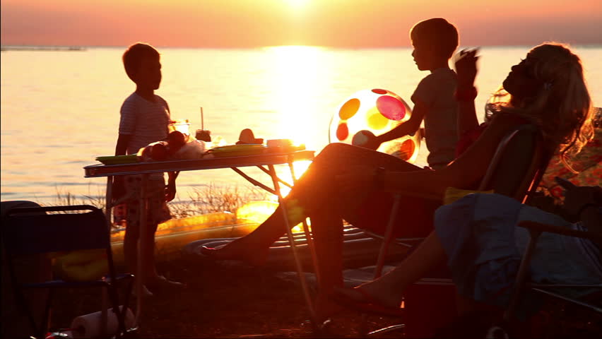 Family is enjoying in sunset on the beach
