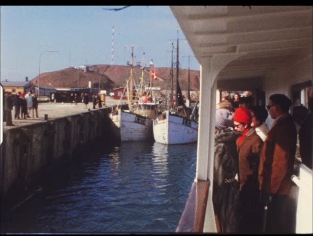HELGOLAND, GERMANY - CIRCA 1970s: Group of people on boat take trip to Helgoland, Germany circa 1970s. Vintage 8mm film.
