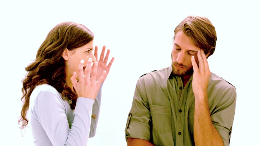 Girlfriend shouting at boyfriend as he rolls his eyes on white background in slow motion