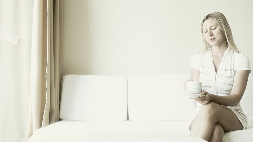 girl in a hotel room drinking coffee    