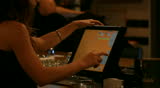 Bartender woman typing on computer  