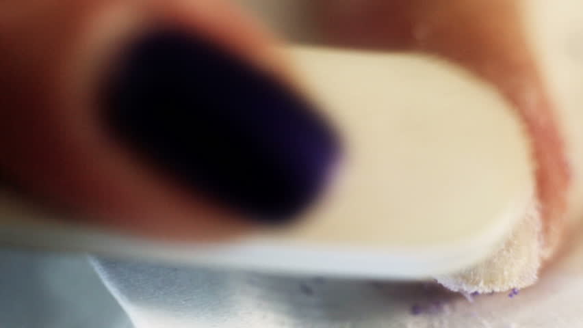 Woman removing the gel like nail polish, after it was soften by gel remover in other related stock video.