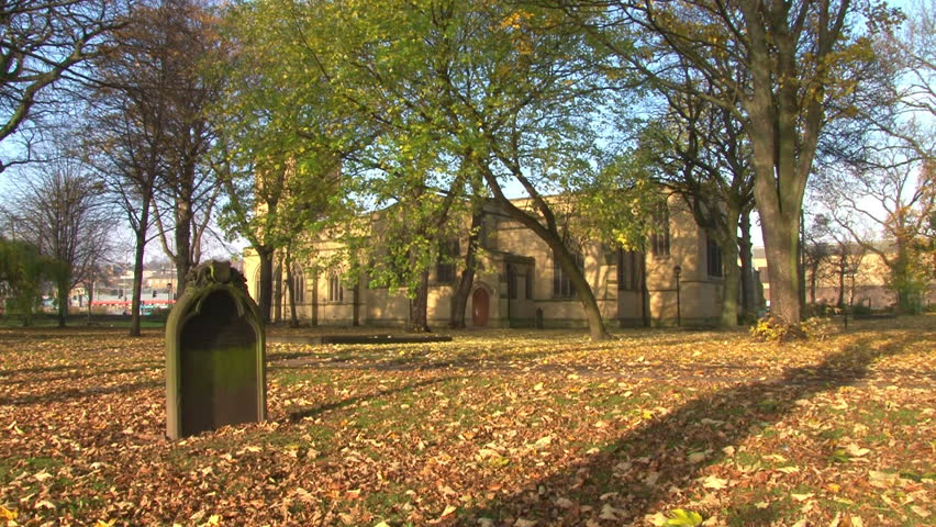 A single gravestone in a churchyard.