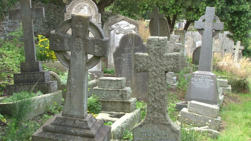 Old stone headstones in a churchyard.