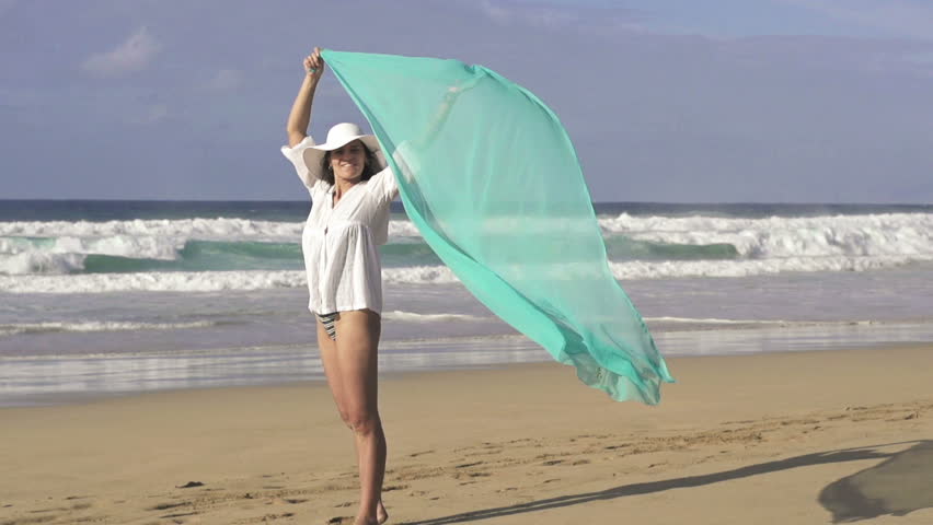 Sexy woman with pareo standing on beautiful beach
