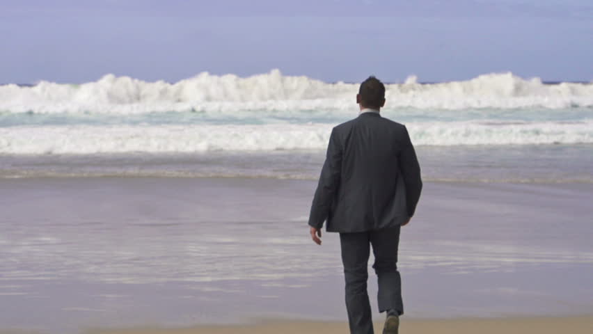 Businessman relaxing on the beach, super slow motion, shot at 240fps
