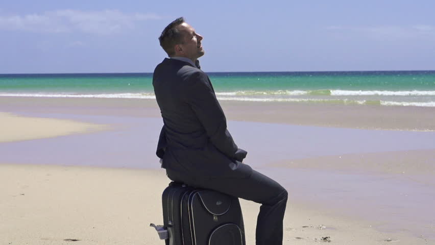 Businessman relaxing on the beach, super slow motion, shot at 240fps
