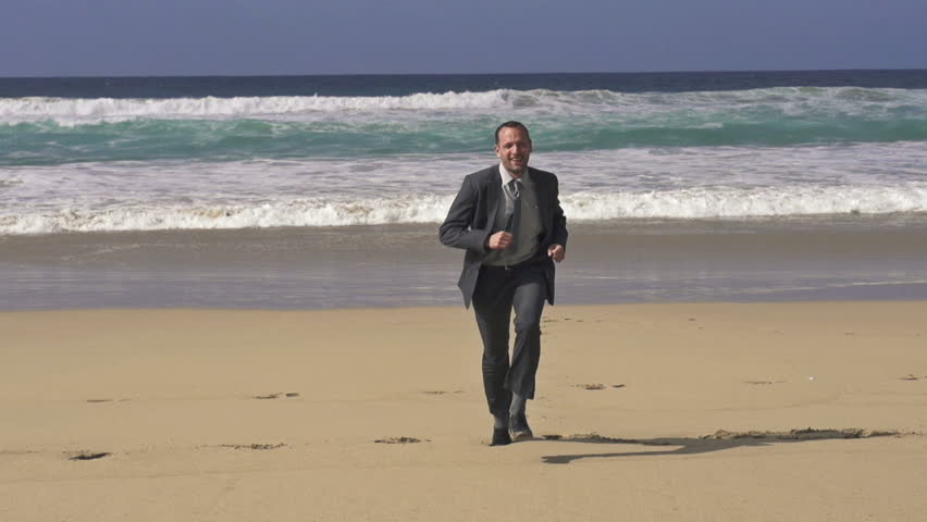 Excited businessman screaming by the sea, super slow motion, shot at 240fps
