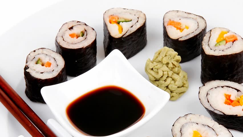 Maki Sushi : Maki Rolls and California rolls made of fresh raw Salmon(sake) Tuna(maguro) and Eel(unagi) . dish with sticks 1920x1080 intro motion slow hidef hd