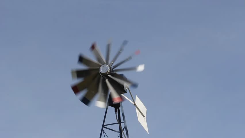 windmill aerator turning in the wind against a blue background